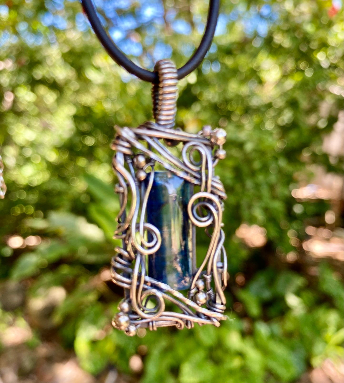 Blue Kyanite and Sterling Silver wire wrap pendant.