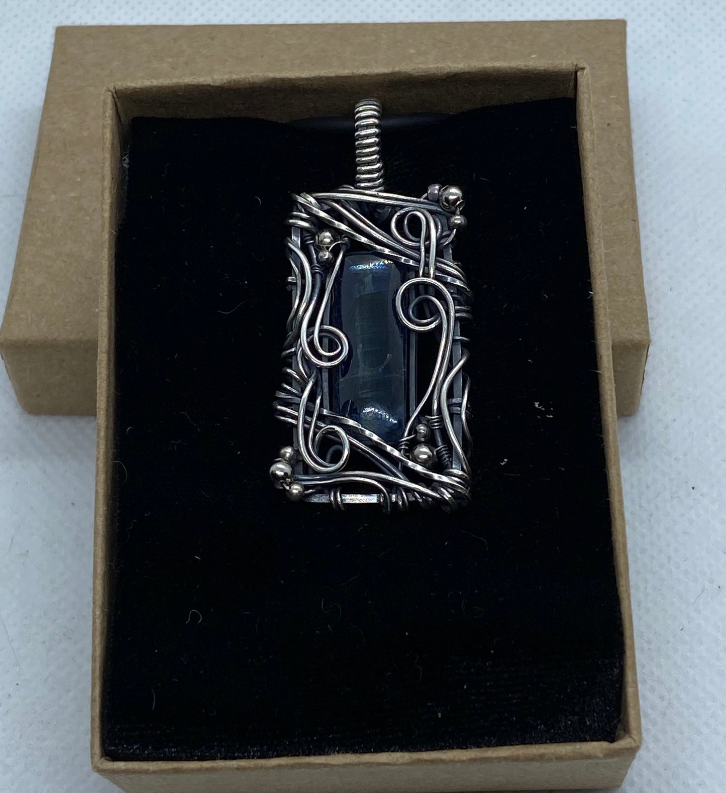 Blue Kyanite and Sterling Silver wire wrap pendant.