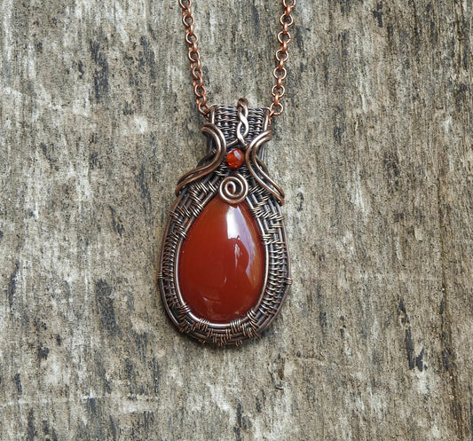 handmade carnelian and natural copper wire wrap pendant.