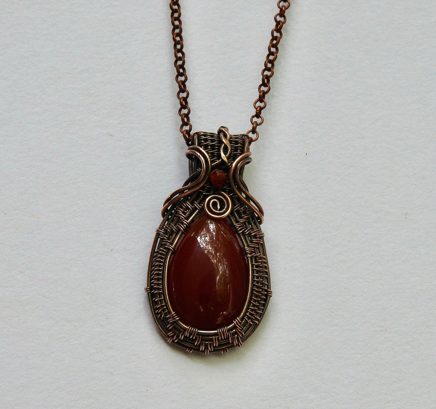 handmade carnelian and natural copper wire wrap pendant.